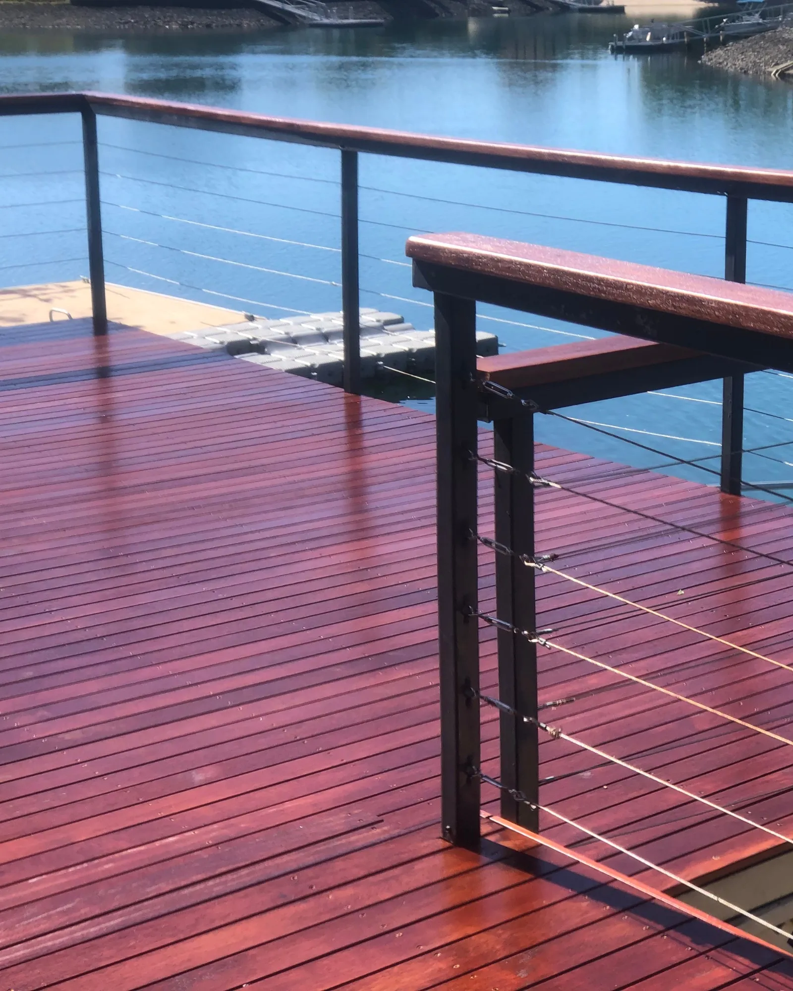 Mahogany hardwood deck with cable-rail balustrade overlooking a Gold Coast marina